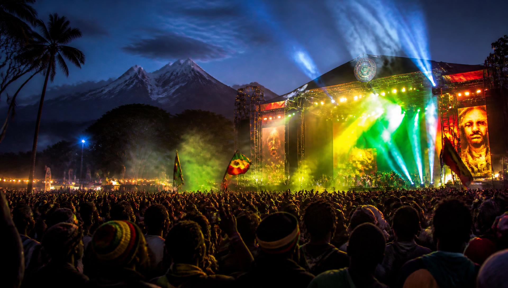 ICEFEST crowd in Embu at night with green, gold and red stage lights